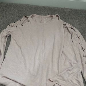 Long sleeve light sweater. Super soft. Sleeves are intertwined with fabric.